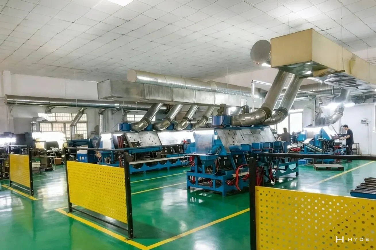 Our polishing line, with its extraction ducting overhead — the stage that decides whether a satin finish is even across a whole production run