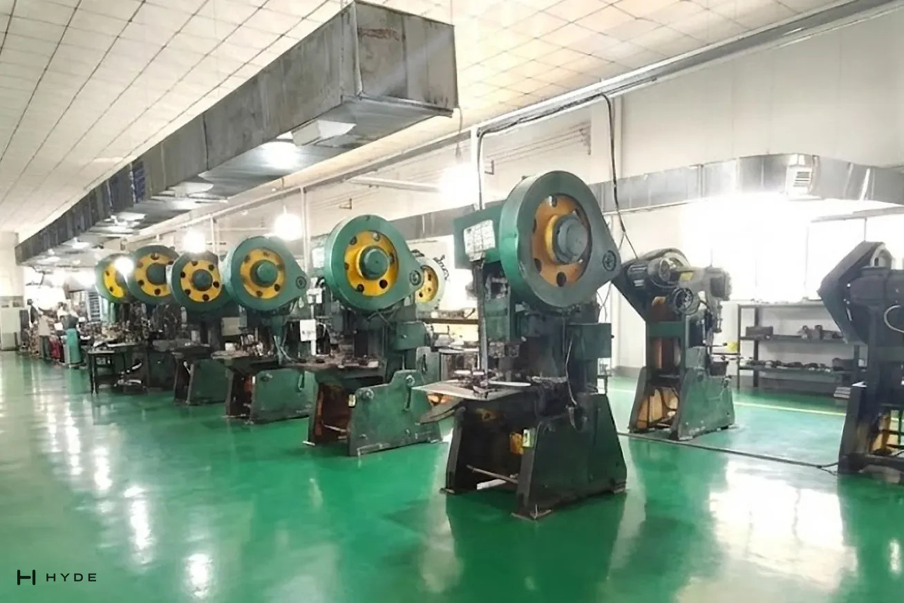 Our press shop: a row of mechanical punch presses with their tooling set, where lock cases, plates and handle blanks are stamped