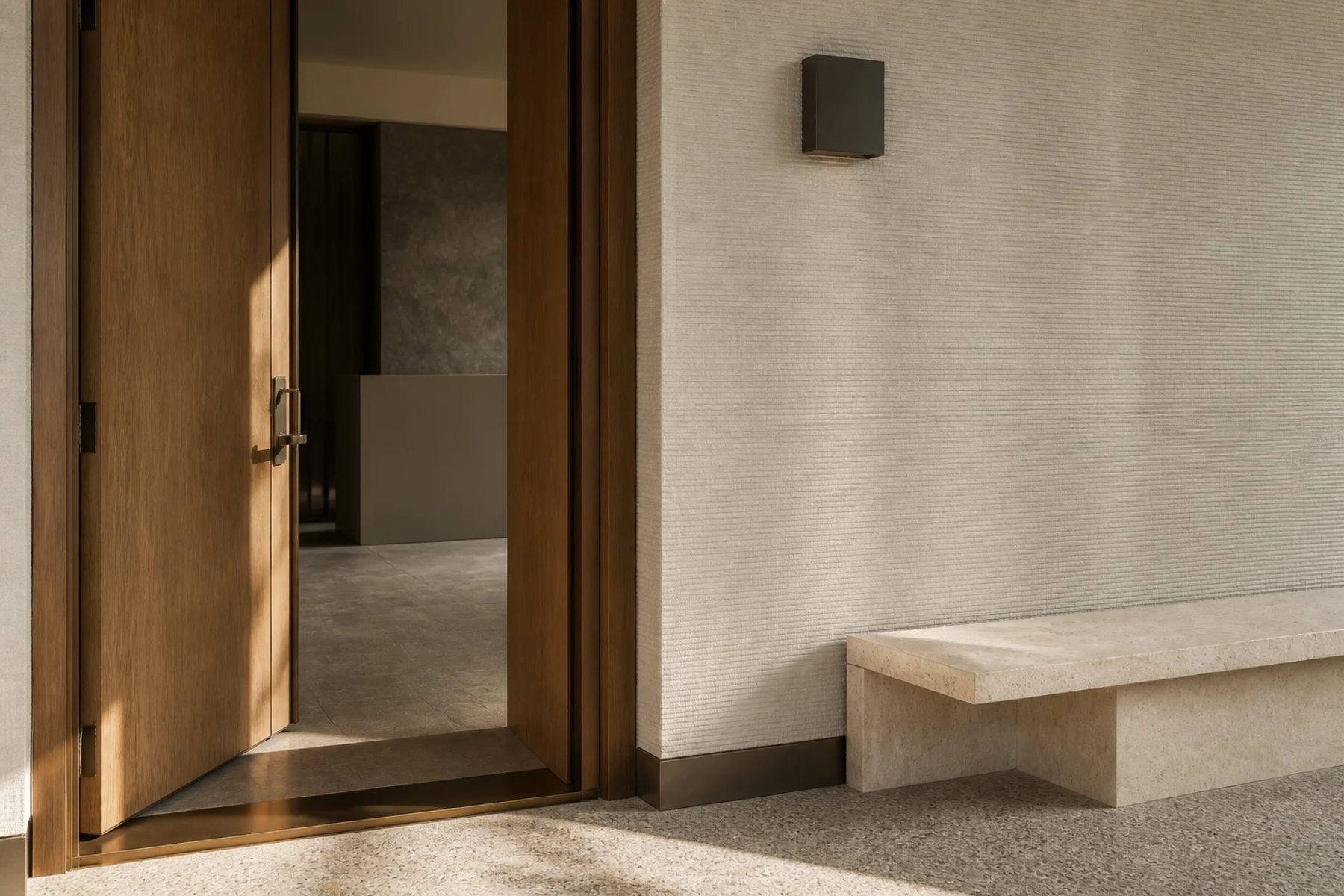 Representative boutique-hospitality threshold in timber, bronze and stone